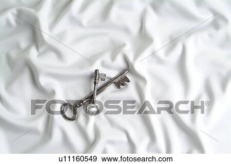 Stock Photo - Keys on white silk. Fotosearch