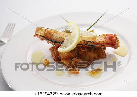 Stock Photo - King crab on potato and tomato mash. Fotosearch