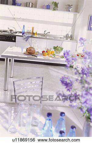 Stock Photograph - Kitchen tables with food and glasses. Fotosearch