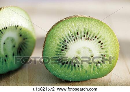 Stock Image - Kiwi sliced in half, close up. Fotosearch