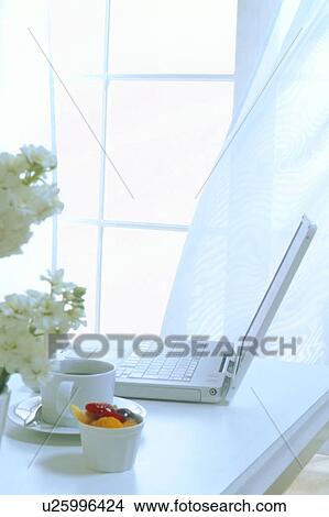Picture - Laptop computer with coffee and snacks. Fotosearch