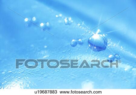 Stock Image - Light sparkling off water drop. Fotosearch