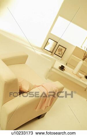 Stock Image - Living room with armchair and coffee table. Fotosearch