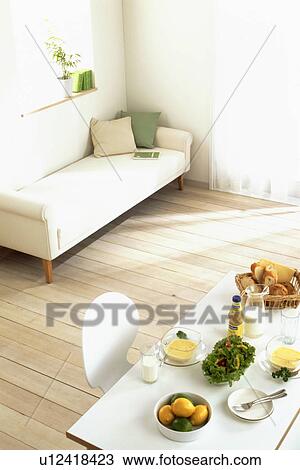 Stock Image - Living room with chaise longue and table arrangement. Fotosearch