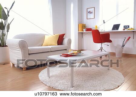 Stock Image - Living room with office desk. Fotosearch