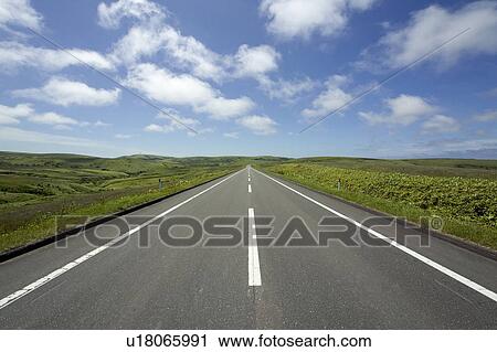 Stock Image - Long road in nature, Hokkaido Prefecture, Japan. Fotosearch