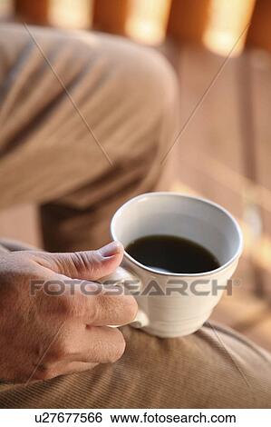 Man holding coffee View Large Photo Image Stock Photograph - Man holding coffee. Fotosearch