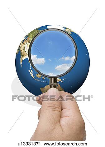 Man looking into globe though magnifying glass View Large Photo Image Stock Image - Man looking into globe though magnifying glass. Fotosearch