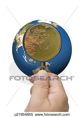 Man looking into globe though magnifying glass View Large Photo Image Stock Photography - Man looking into globe though magnifying glass. Fotosearch