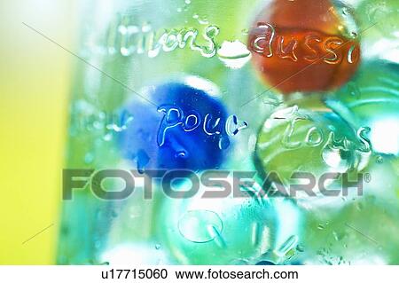 Stock Image - Marbles in a Glass Jar. Fotosearch