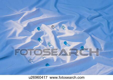 Marbles on white cloth View Large Photo Image Stock Photo - Marbles on white cloth. Fotosearch