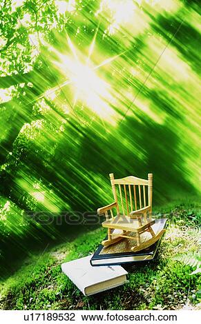 Stock Image - Miniature rocking chair in a forest. Fotosearch