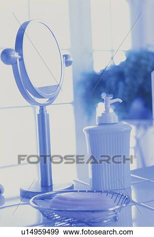 Stock Photo - Mirror and hand soap in bathroom. Fotosearch