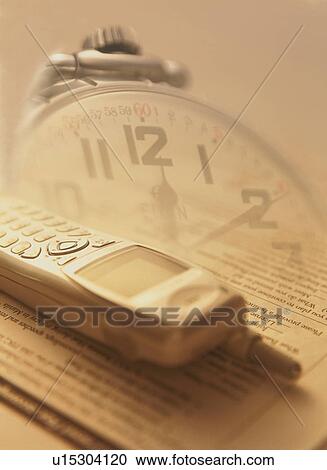 Stock Image - Mobile phone and clock - digital composite. Fotosearch