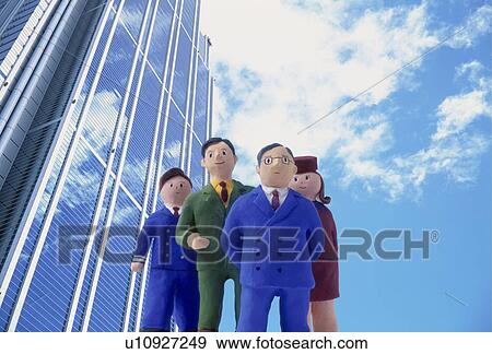 Stock Photo - Model businessmen under skyscraper. Fotosearch
