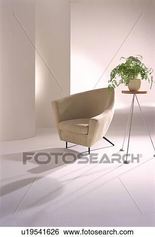 Modern beige armchair and pot plant View Large Photo Image Stock Photograph - Modern beige armchair and pot plant. Fotosearch