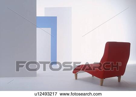 Stock Photo - Modern red armchair in room with wall segments. Fotosearch