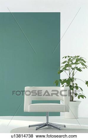 Stock Photo - Modern white chair in room with potted tree. Fotosearch