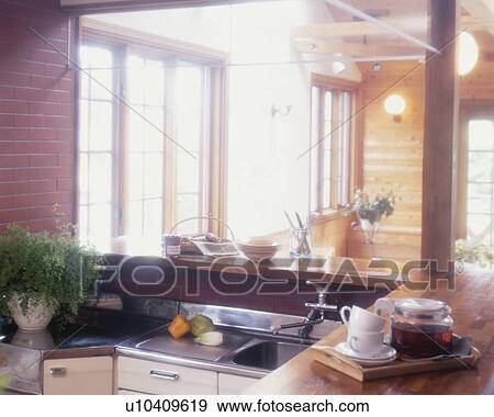 Stock Photo - Morning sun illuminates a modern kitchen. Fotosearch