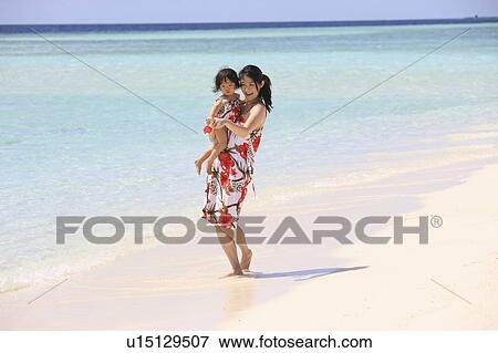 Mother and daughter at the beach, Maldive Islands View Large Photo Image Stock Photo - Mother and daughter at the beach, Maldive Islands. Fotosearch