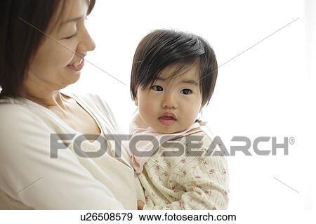 Stock Photo - Mother holding daughter. Fotosearch