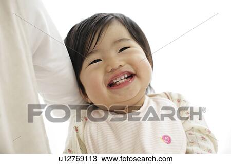 Mother holding smiling daughter View Large Photo Image Stock Image - Mother holding smiling daughter. Fotosearch