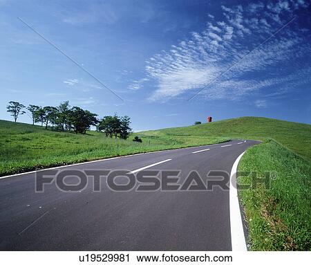 Stock Image - Mountain road in summer, Hokkaido prefecture, Japan. Fotosearch