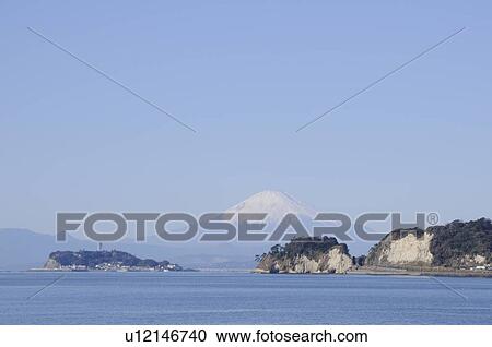 Stock Image - Mt Fuji and Enoshima Island viewed from Kamakura. Enoshima, Kamakura, Kanagawa Prefecture, Japan. Fotosearch