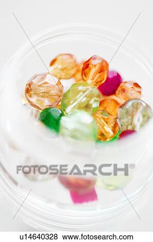 Multicoloured beads in a jar View Large Photo Image Stock Photo - Multicoloured beads in a jar. Fotosearch