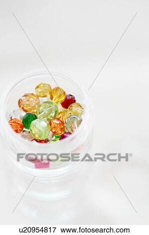 Stock Photo - Multicoloured beads in a jar. Fotosearch