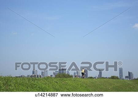 Stock Photo - Office buildings from field, copy space, Tokyo prefecture, Japan. Fotosearch