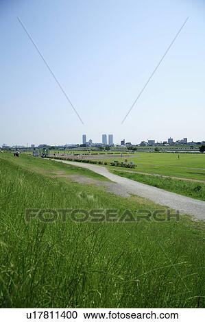 Stock Image - Office buildings from field, Tokyo prefecture, Japan. Fotosearch