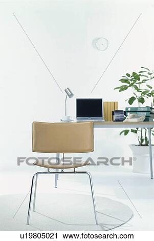Office chair with desk in background View Large Photo Image Stock Image - Office chair with desk in background. Fotosearch