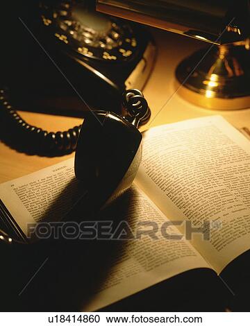 Old telephone and an open book View Large Photo Image Stock Image - Old telephone and an open book. Fotosearch