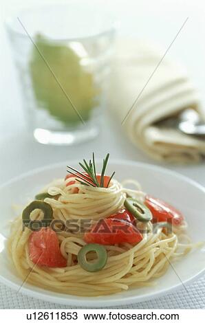 Stock Image - Olive and tomato spaghetti with rosemary garnish. Fotosearch