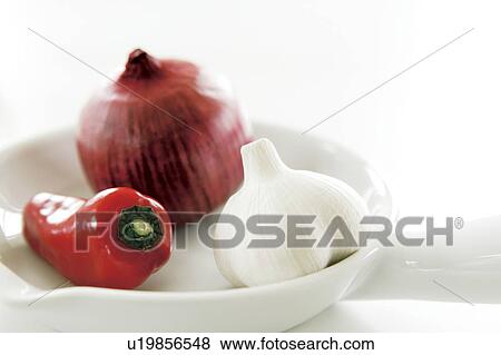 Stock Photo - Onion, red bell pepper, and garlic, white background. Fotosearch