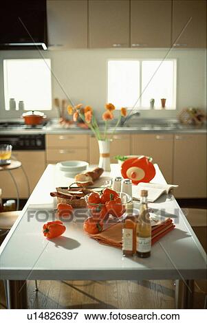 Stock Photo - Orange bell peppers on kitchen table. Fotosearch