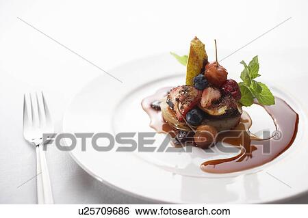 Stock Photograph - Oven roasted fruit with berry compote. Fotosearch