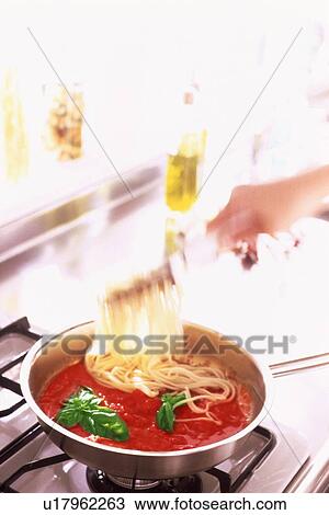 Pasta being mixed with pasta sauce and herbs View Large Photo Image Stock Image - Pasta being mixed with pasta sauce and herbs. Fotosearch