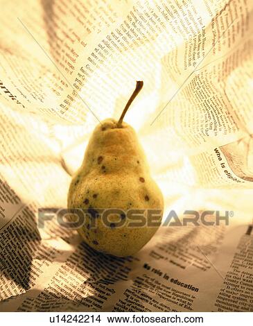 Picture - Pear in newspaper. Fotosearch