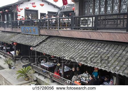 Stock Photograph - People in restaurant on the side of river, China. Fotosearch