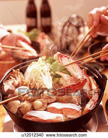 Stock Image - People sharing seafood dish. Fotosearch