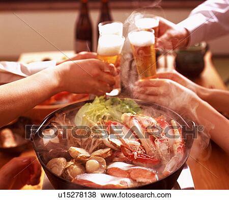 People toasting with beer over seafood dish View Large Photo Image Stock Photo - People toasting with beer over seafood dish. Fotosearch