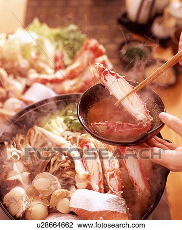 Person dipping crab leg in sauce View Large Photo Image Stock Image - Person dipping crab leg in sauce. Fotosearch
