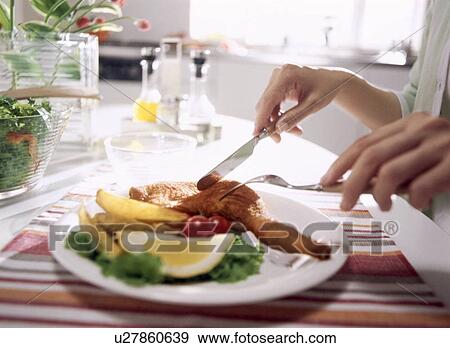 Person eating meal at table View Large Photo Image Stock Photo - Person eating meal at table. Fotosearch