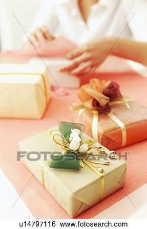 Person gift wrapping presents View Large Photo Image Stock Photograph - Person gift wrapping presents. Fotosearch
