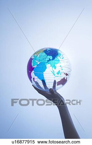Stock Photography - Person holding transparent globe. Fotosearch