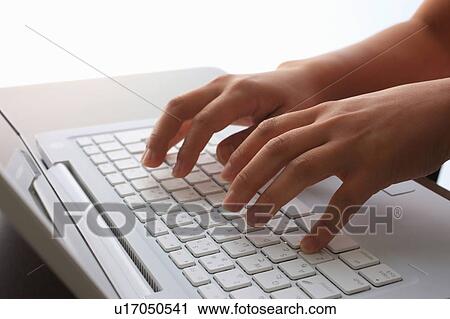 Person typing on laptop View Large Photo Image Stock Image - Person typing on laptop. Fotosearch