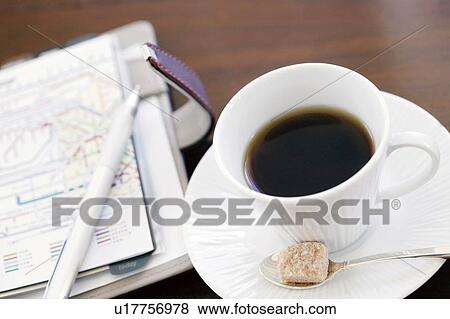 Personal organizer and cup of coffee View Large Photo Image Stock Photo - Personal organizer and cup of coffee. Fotosearch
