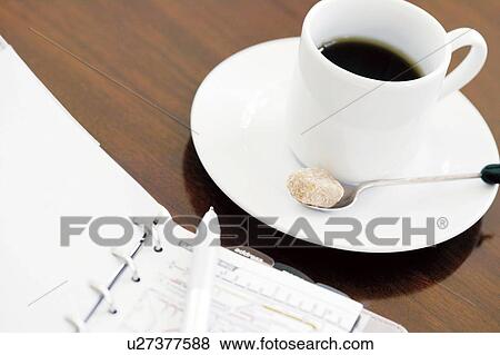 Stock Photo - Personal organizer and cup of coffee. Fotosearch